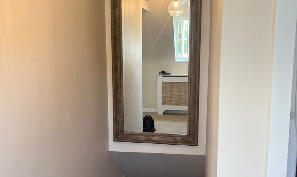 mirror above stairs on plasterboard wall